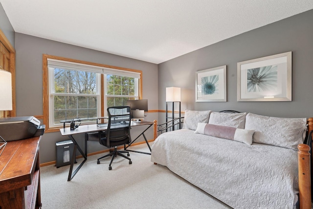 bedroom with baseboards and carpet