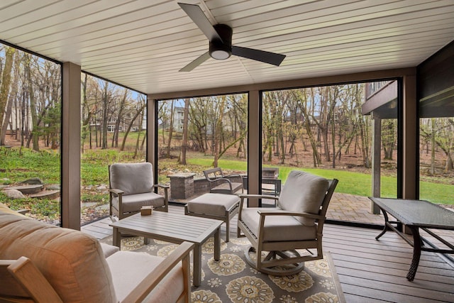 sunroom / solarium with ceiling fan, a wealth of natural light, and an outdoor hangout area