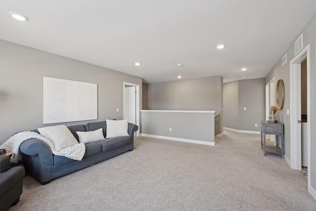 living room with baseboards, recessed lighting, and light carpet