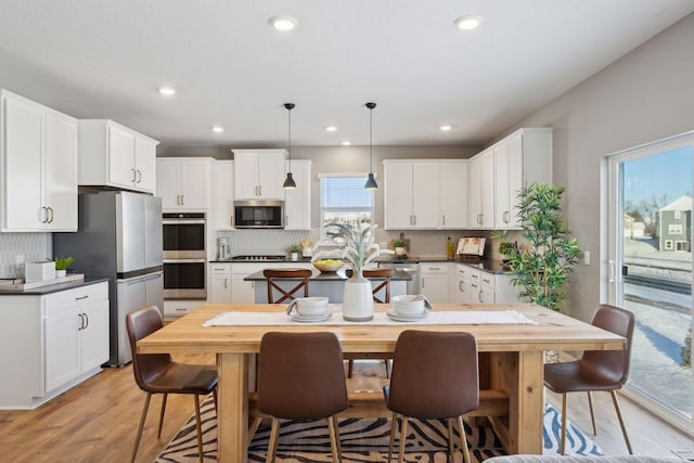 dining space featuring recessed lighting and light wood-style floors