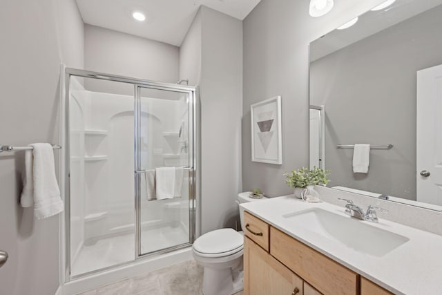 full bath featuring tile patterned flooring, toilet, a stall shower, and vanity