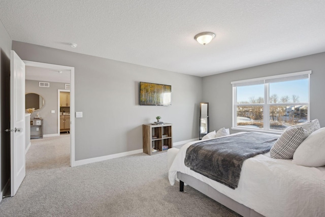 bedroom featuring light carpet, baseboards, visible vents, and a textured ceiling