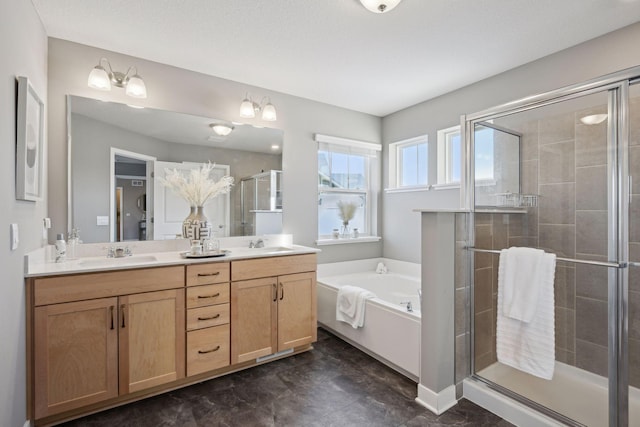 full bath with a bath, a stall shower, double vanity, and a sink