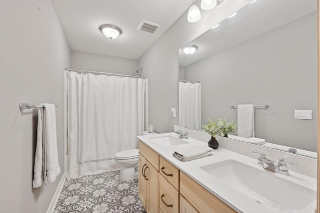 full bath featuring double vanity, visible vents, a sink, and toilet