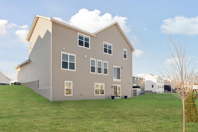 back of house with a yard and fence