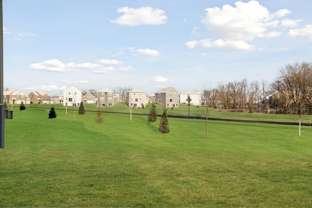 view of home's community featuring a residential view and a lawn