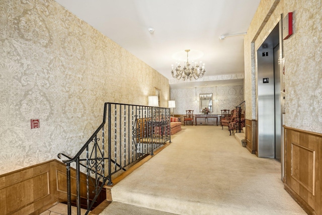 8621 Basswood Rd Unit 32, Eden Prairie, MN 55344 - hall featuring wallpapered walls, an inviting chandelier, wainscoting, and an upstairs landing