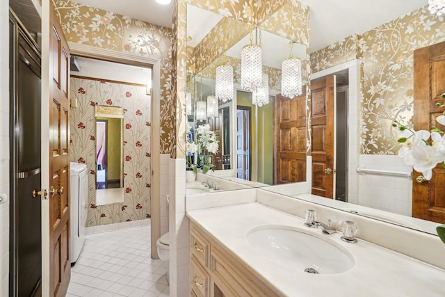 8621 Basswood Rd Unit 32, Eden Prairie, MN 55344 - bathroom with washer / clothes dryer, vanity, a chandelier, tile patterned floors, and wallpapered walls