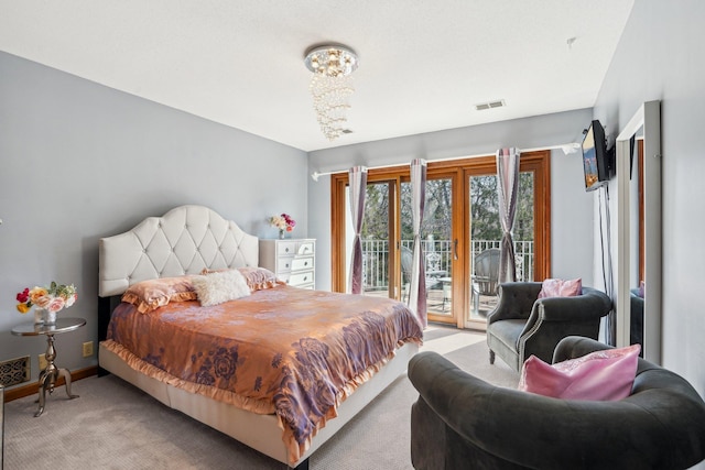 8621 Basswood Rd Unit 32, Eden Prairie, MN 55344 - bedroom featuring access to outside, a notable chandelier, light carpet, and visible vents