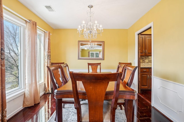 8621 Basswood Rd Unit 32, Eden Prairie, MN 55344 - dining area featuring visible vents, an inviting chandelier, and dark wood-style floors