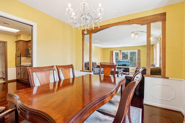 8621 Basswood Rd Unit 32, Eden Prairie, MN 55344 - dining room with visible vents, arched walkways, a chandelier, and dark wood finished floors
