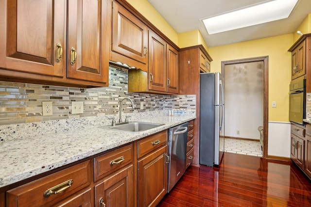 8621 Basswood Rd Unit 32, Eden Prairie, MN 55344 - kitchen with dark wood finished floors, tasteful backsplash, light stone counters, a sink, and stainless steel appliances