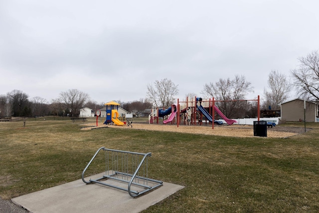 community jungle gym featuring a lawn