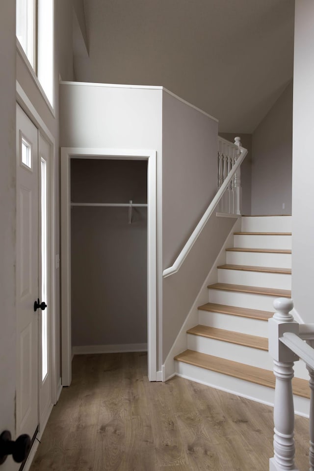 stairway with baseboards and wood finished floors