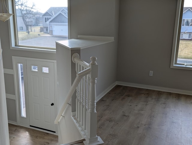 entrance foyer featuring baseboards and wood finished floors