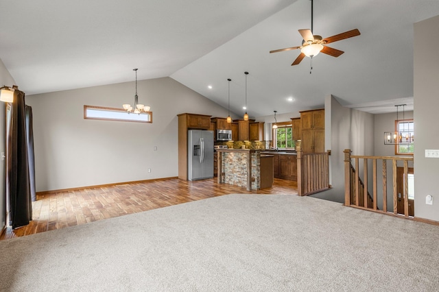 6387 203rd Ct N, Forest Lake, MN 55025 - unfurnished living room featuring a chandelier, light carpet, a ceiling fan, light wood-style floors, and recessed lighting
