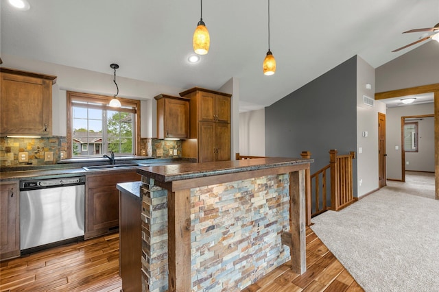 6387 203rd Ct N, Forest Lake, MN 55025 - kitchen featuring stainless steel dishwasher, dark countertops, lofted ceiling, a sink, and brown cabinets