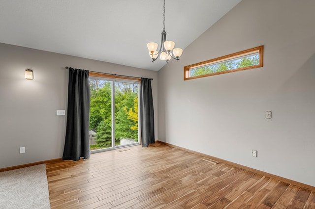 6387 203rd Ct N, Forest Lake, MN 55025 - spare room with a chandelier, healthy amount of natural light, light wood-type flooring, and high vaulted ceiling