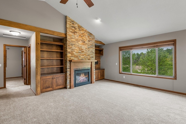 6387 203rd Ct N, Forest Lake, MN 55025 - unfurnished living room with light carpet, ceiling fan, a glass covered fireplace, and vaulted ceiling