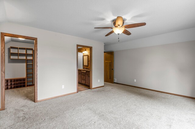 6387 203rd Ct N, Forest Lake, MN 55025 - unfurnished bedroom with a walk in closet, light colored carpet, a closet, baseboards, and connected bathroom