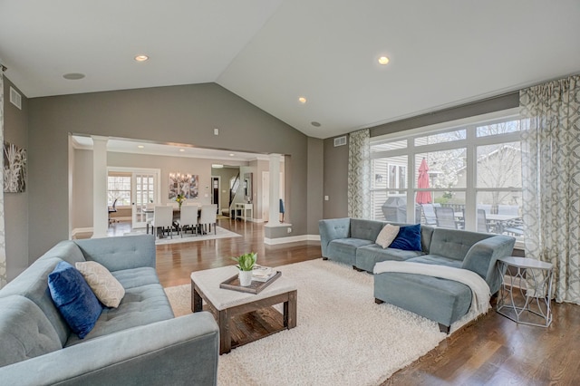 living area featuring recessed lighting, ornate columns, wood finished floors, and visible vents