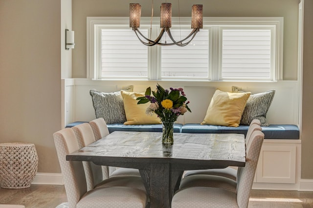 dining room featuring baseboards, wood finished floors, and a chandelier