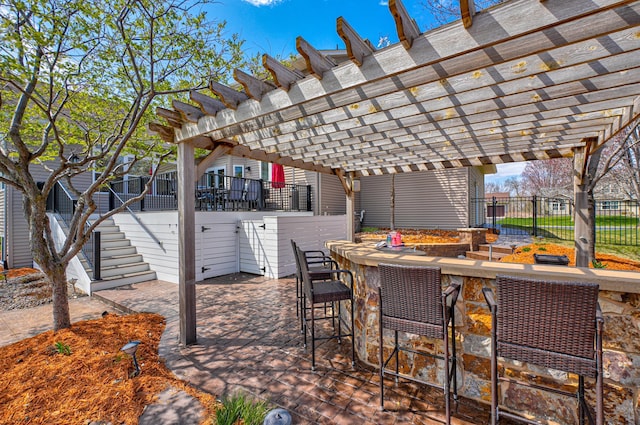 view of patio featuring a pergola, fence, stairs, and outdoor dry bar