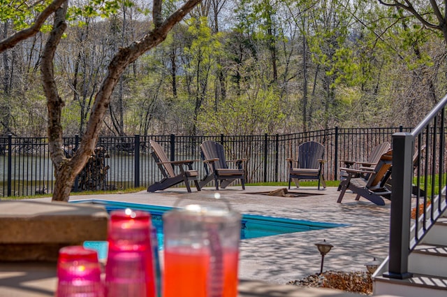view of swimming pool with a patio, fence, and a fenced in pool