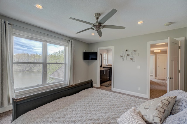 carpeted bedroom with baseboards, a ceiling fan, recessed lighting, and connected bathroom
