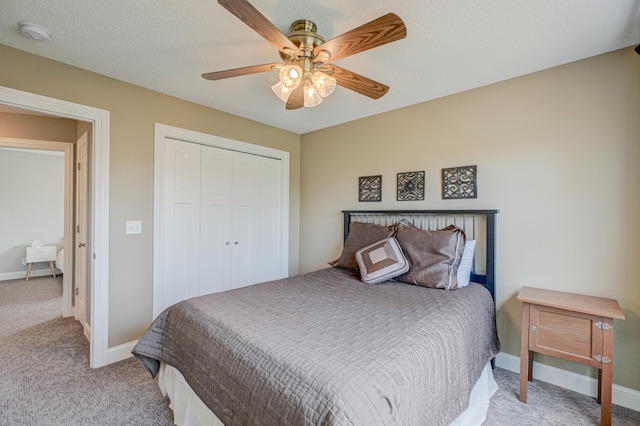 carpeted bedroom featuring baseboards, ceiling fan, and a closet