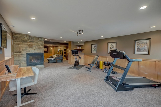 workout area featuring carpet floors, recessed lighting, and wainscoting