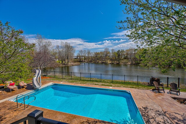 view of swimming pool with a patio, a fenced backyard, a fenced in pool, a water view, and a water slide