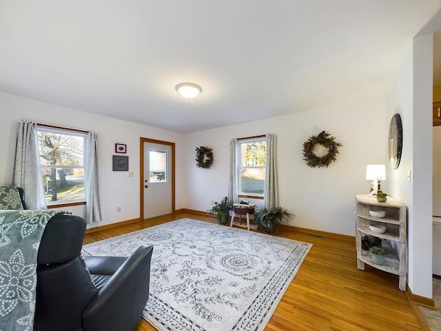 living room featuring light wood-style flooring and baseboards