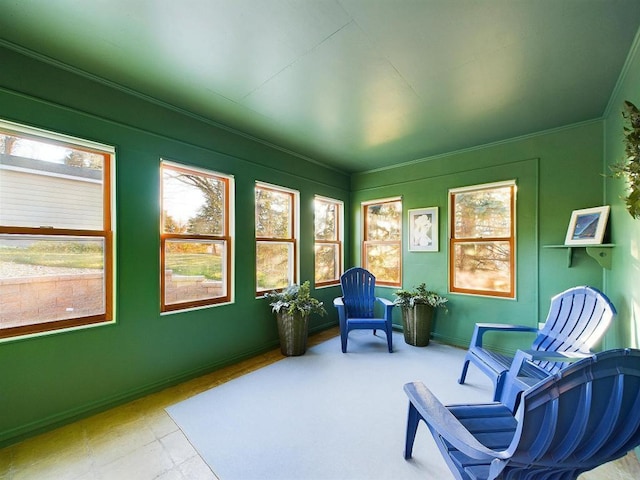 sitting room featuring ornamental molding and baseboards