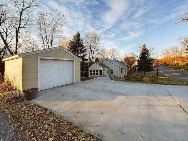 detached garage with concrete driveway