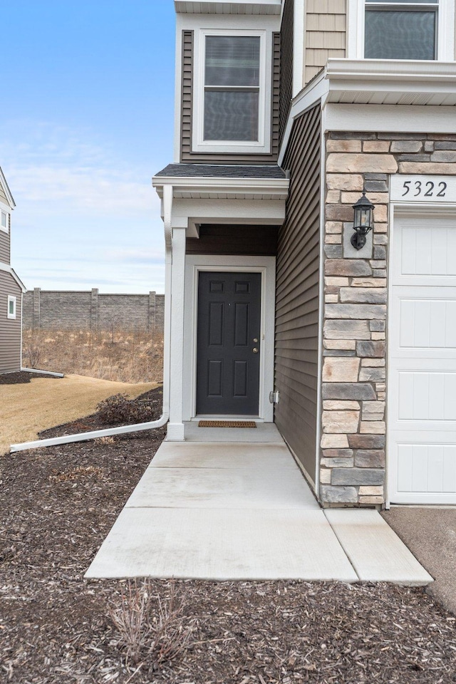 doorway to property featuring stone siding