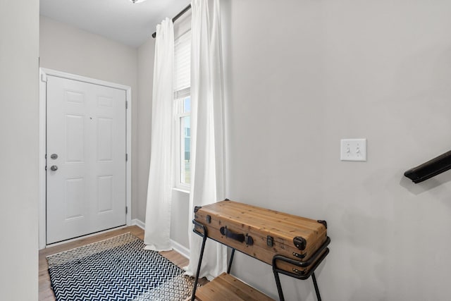 entrance foyer with light wood-style flooring and baseboards