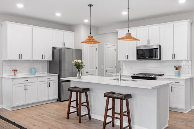 kitchen featuring recessed lighting, a sink, backsplash, and appliances with stainless steel finishes