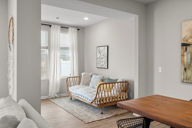 living area with baseboards, recessed lighting, and wood finished floors