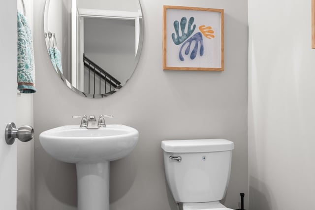 half bathroom featuring toilet