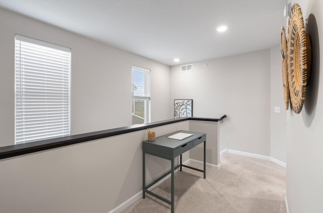 interior space with visible vents, baseboards, recessed lighting, and light colored carpet