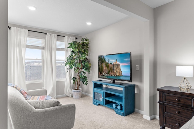 living area with light carpet, baseboards, and recessed lighting