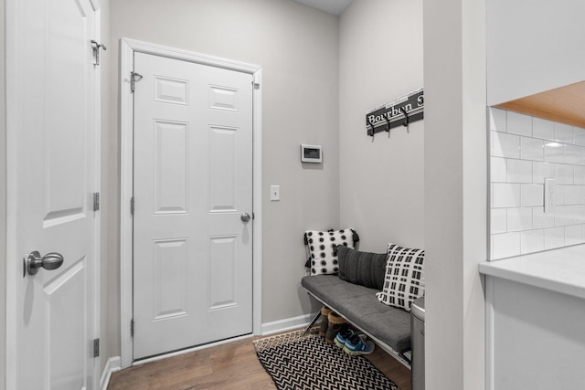 mudroom featuring wood finished floors and baseboards