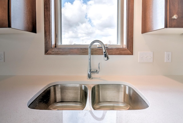 interior details with a sink and light countertops
