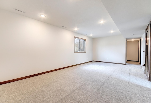 unfurnished room featuring light colored carpet, baseboards, and visible vents