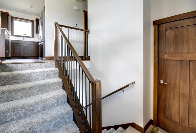 staircase featuring baseboards