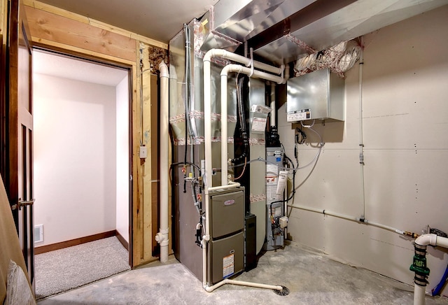 utility room featuring visible vents and water heater
