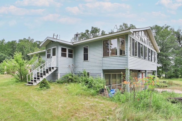 21682 Rebel Rd, Center Twp, MN 56465 - rear view of house with a sunroom and stairway