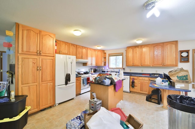 21682 Rebel Rd, Center Twp, MN 56465 - kitchen featuring white appliances, under cabinet range hood, a kitchen island, and dark countertops