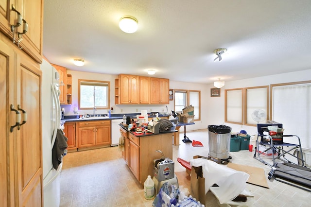 21682 Rebel Rd, Center Twp, MN 56465 - kitchen with open shelves, white dishwasher, a center island, dark countertops, and a textured ceiling